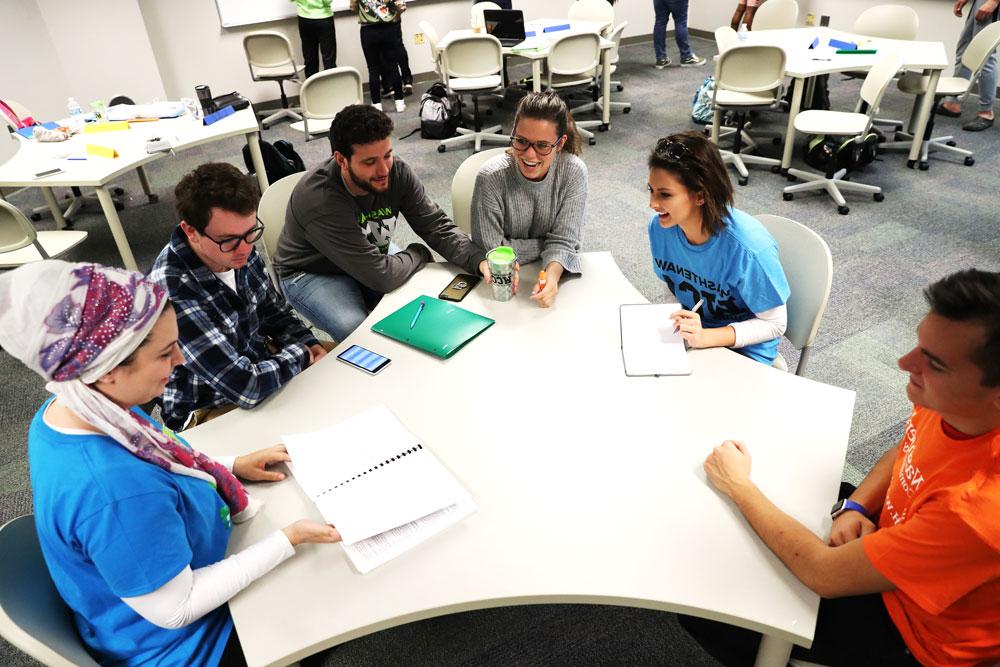 business students working around a table